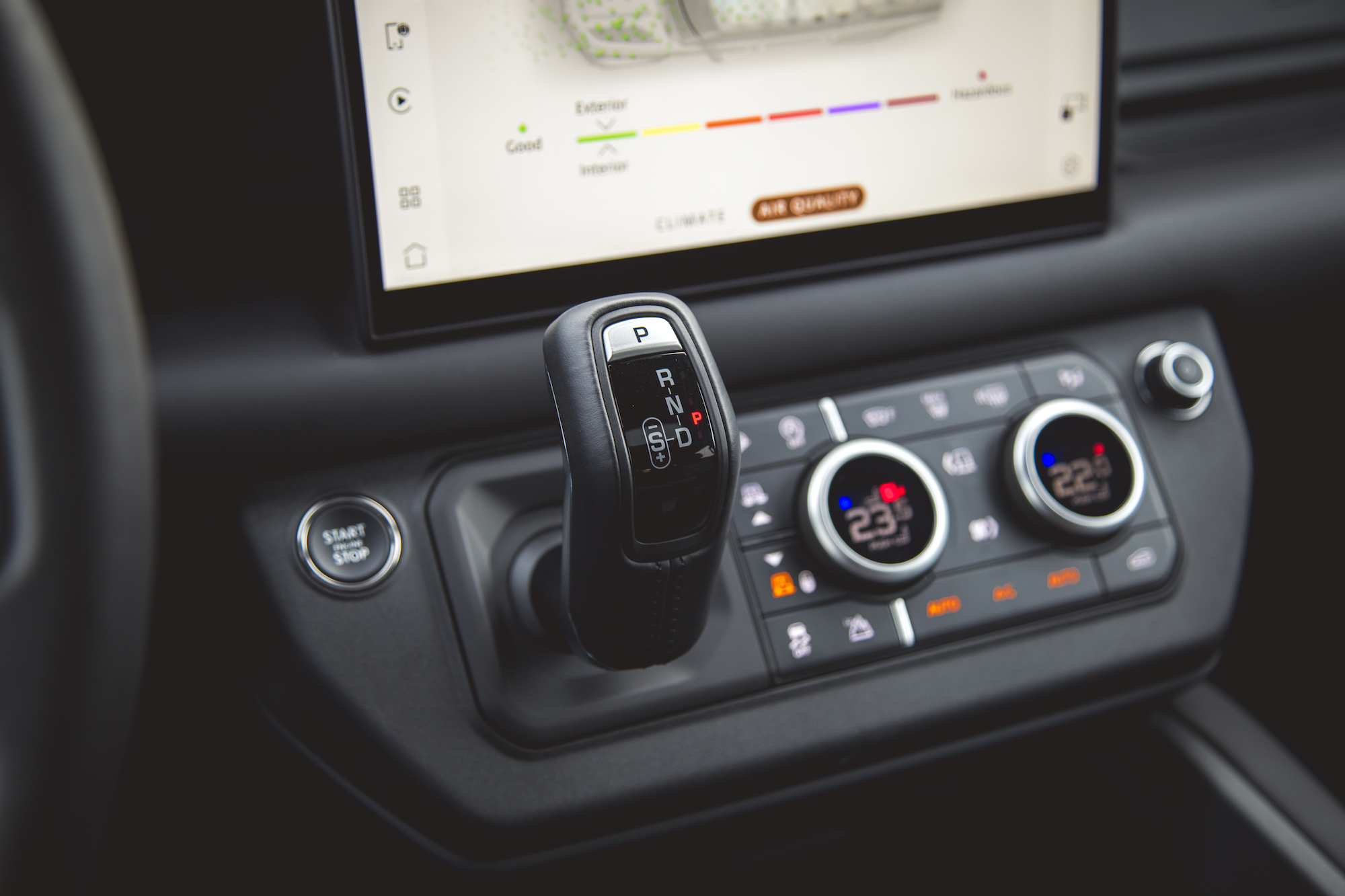 Close-up of the gear shift and climate control panel inside the 2026 Land Rover Defender 130 P400 X-Dynamic SE.