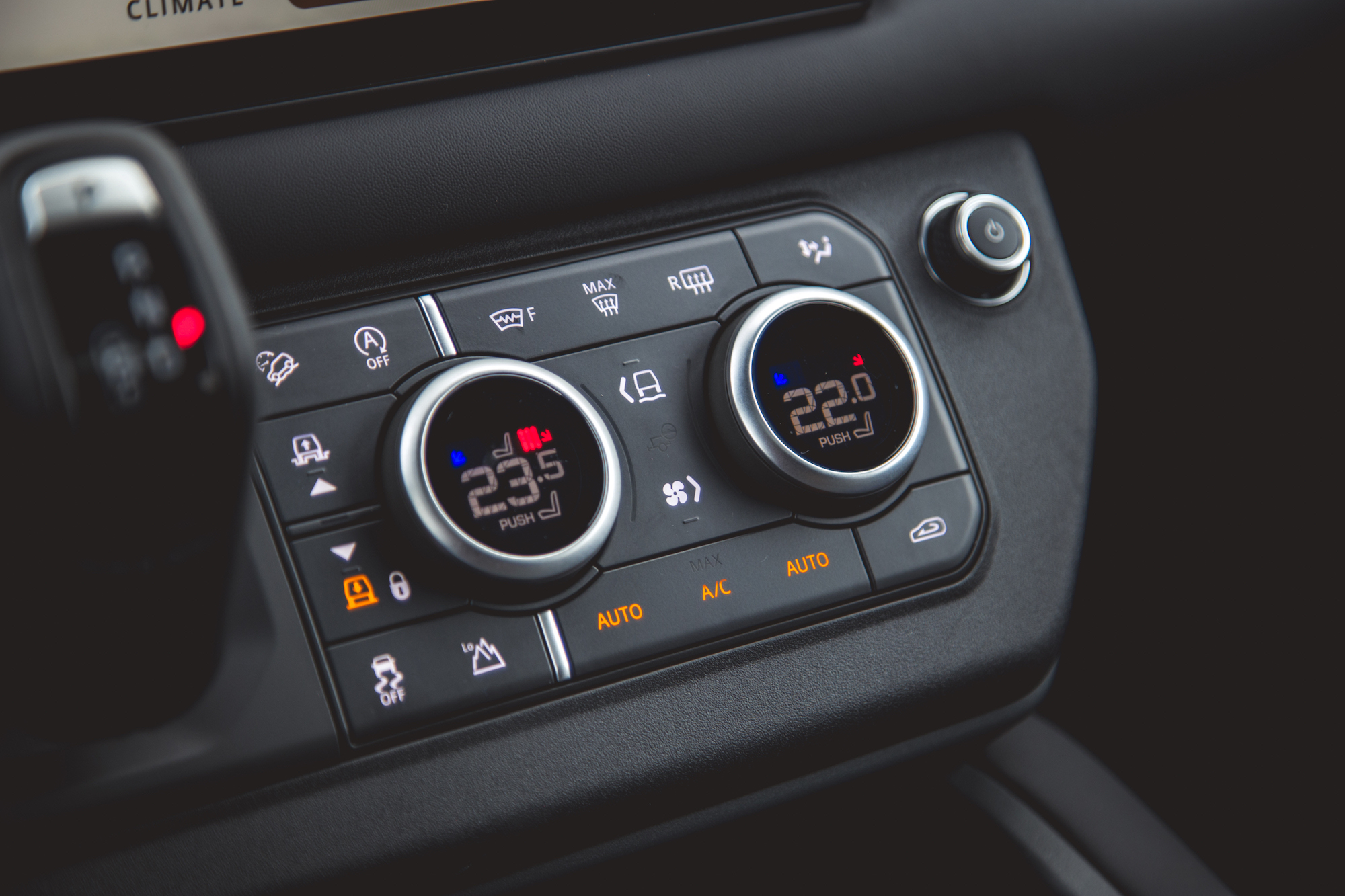 Close-up of the climate control panel in a 2026 Land Rover Defender 130, featuring temperature settings and various control buttons.