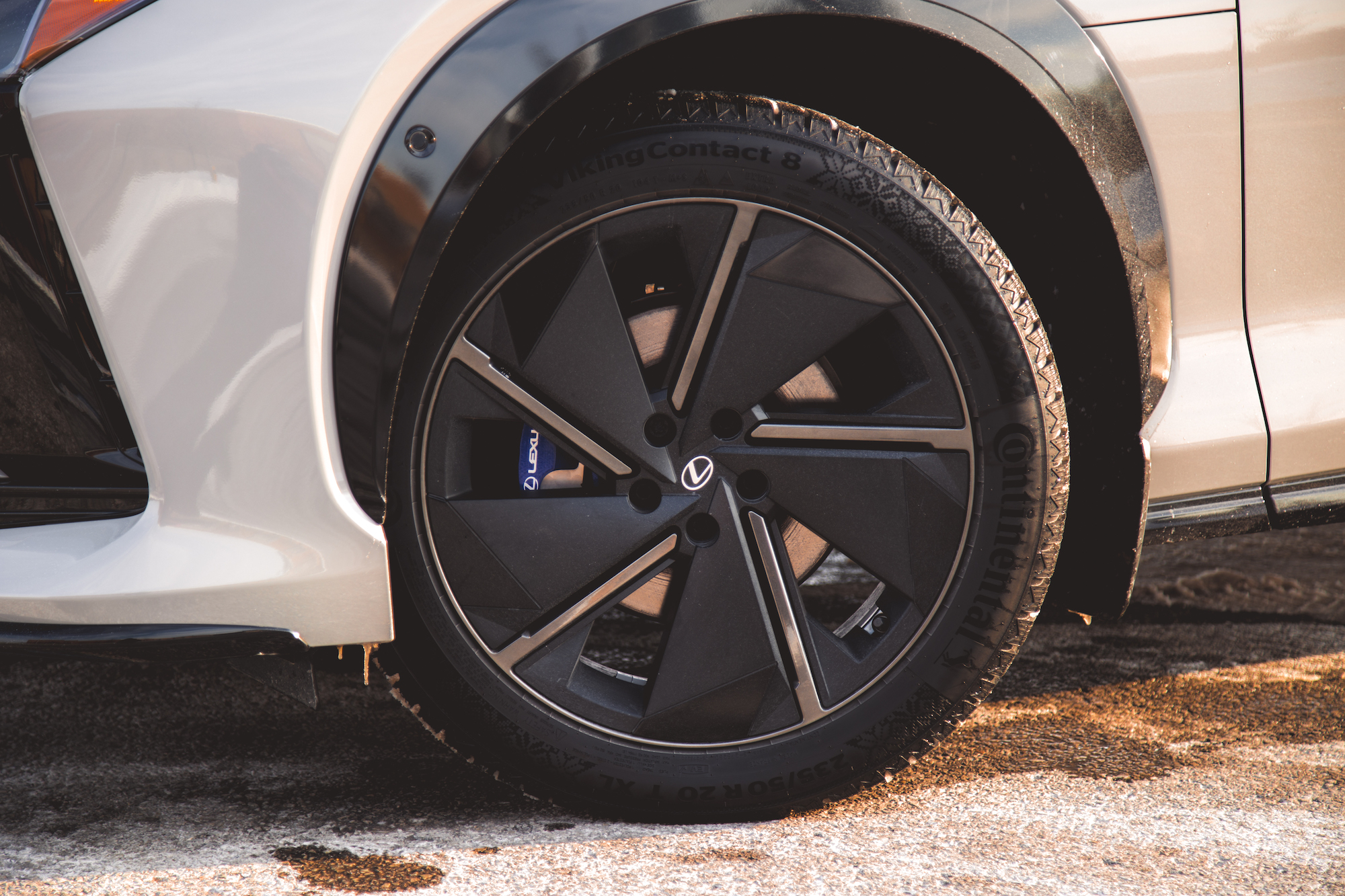 Close-up of a stylish black alloy wheel on a Lexus vehicle, showcasing the intricate design and tire details.