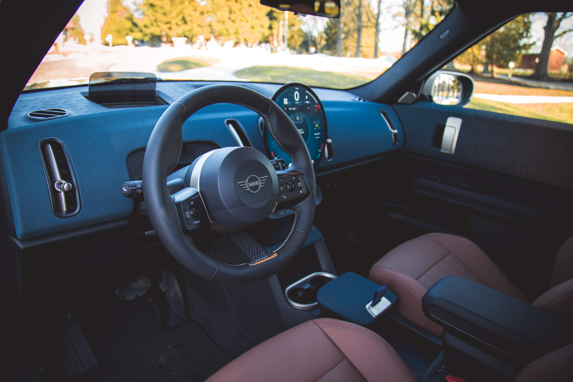 Interior view of a car showcasing the dashboard, steering wheel, and seating with a modern design.
