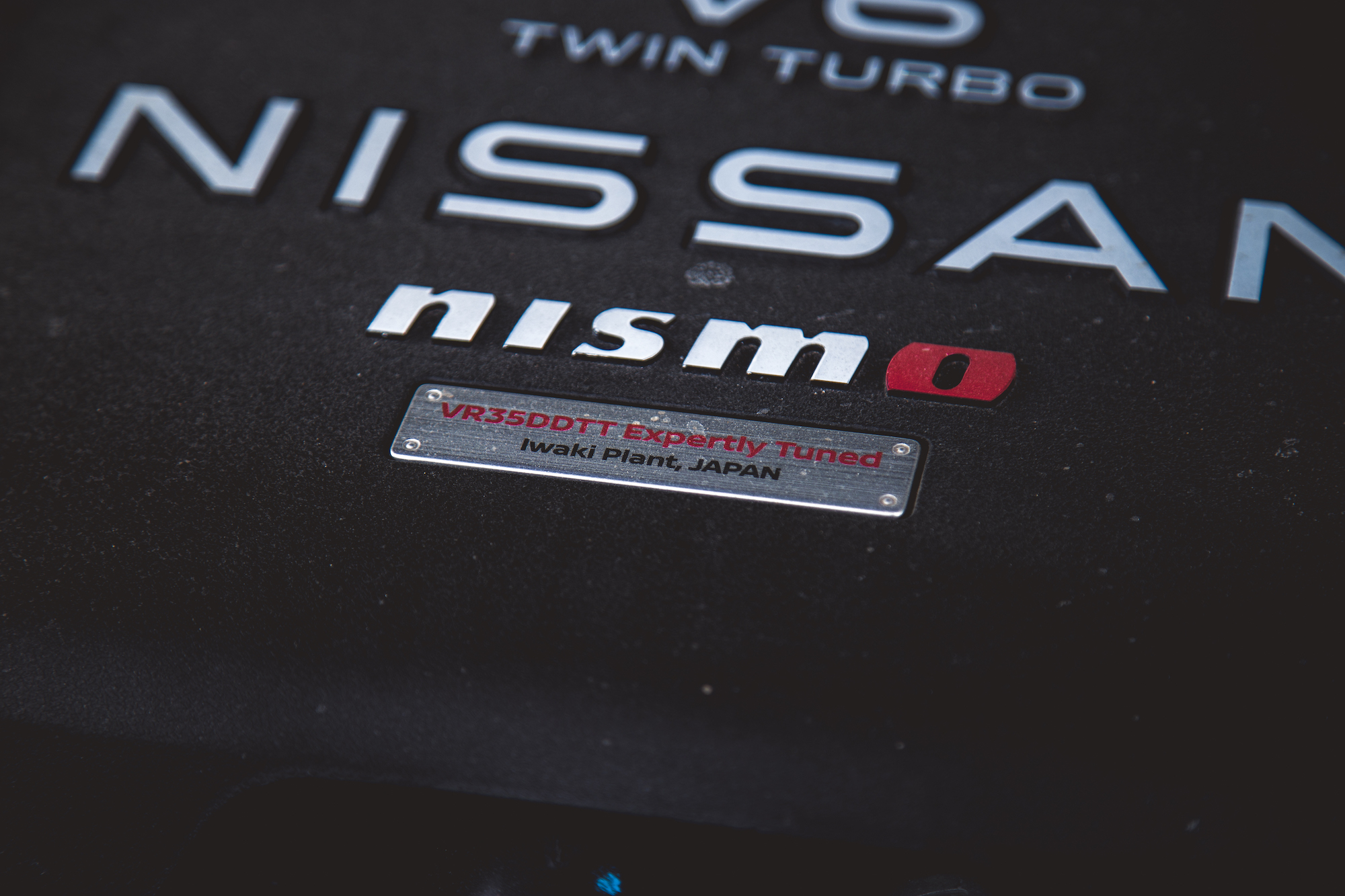 Primer plano de la cubierta del motor Nissan con las palabras 