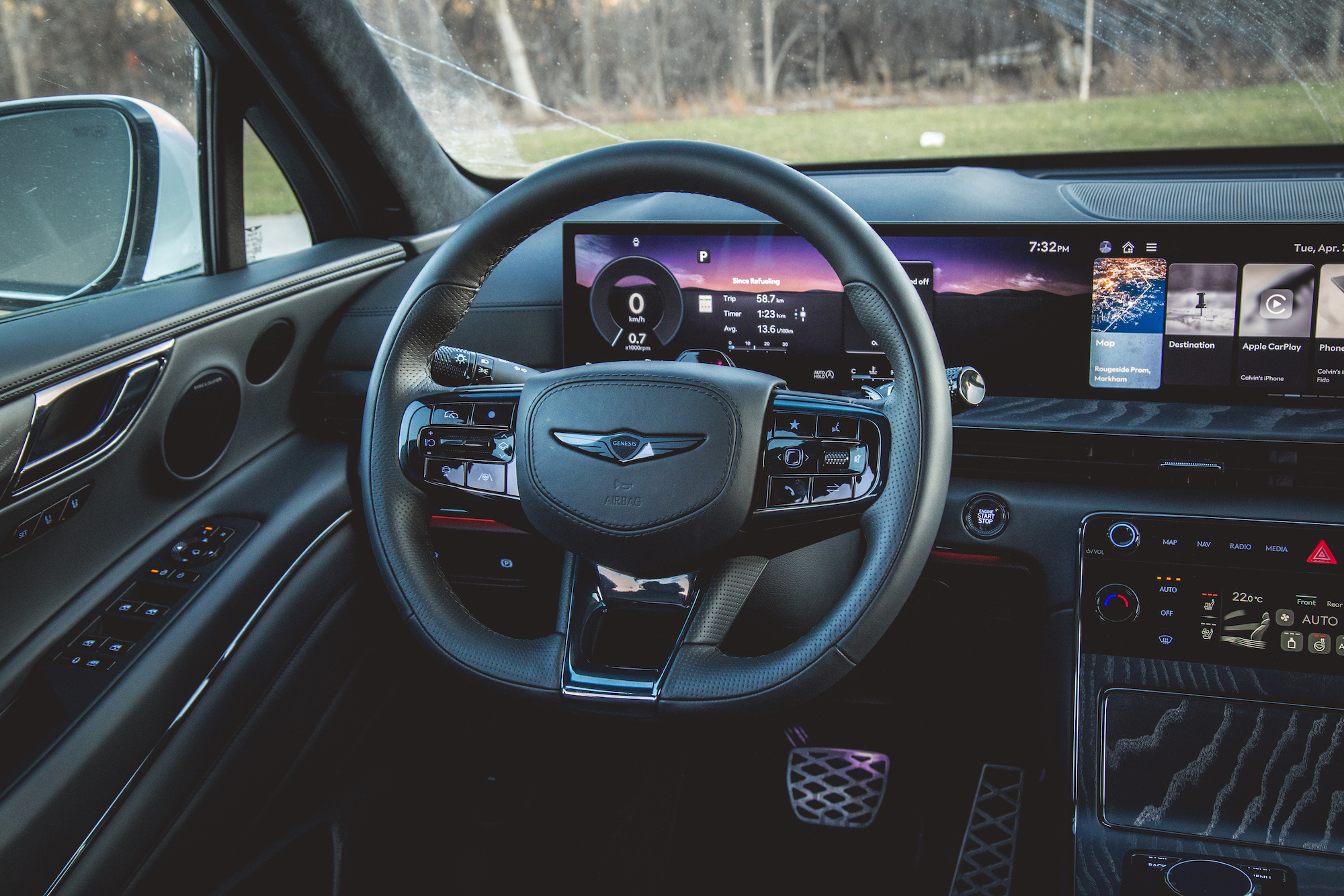 Interior view of a car showcasing the steering wheel, dashboard, and center console with digital displays and controls.